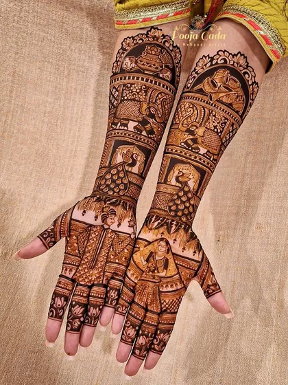 This bridal design features a unique combination of portraits and traditional motifs, including peacocks and elephants, creating a rich and varied look.