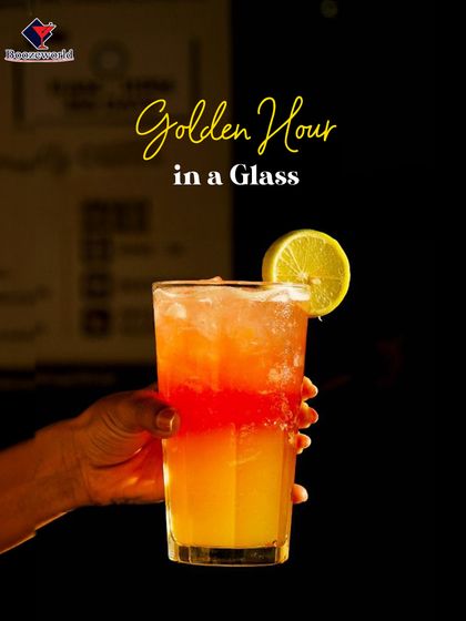 We call this "Golden Hour in a Glass." The beautiful layered colors mimic a sunset, with a sweet orange base and a float of red berry liqueur, garnished with a simple lime wheel.