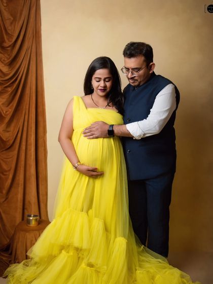 A classic pose for an expecting couple. The gentle placement of hands on the baby bump is a simple but profound way to show your shared love and excitement.
