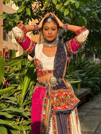 A powerful pose that captures the essence of the character. The headpiece and layered necklaces complete this dramatic look.