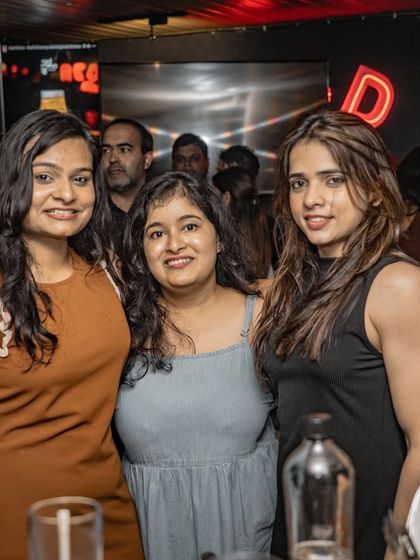 Friends posing for a picture at Red Rhino. My gigs are a place for people to connect and make memories.