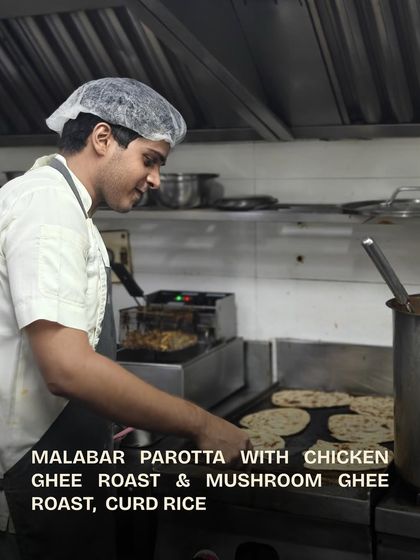 Another chef at the grill, cooking the parottas for the team.