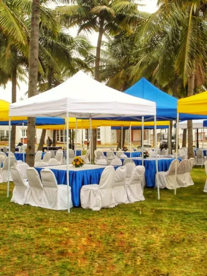 For events that require separate zones, I provide multiple canopy tents. This setup at an outdoor venue uses colorful canopies to create distinct seating or activity areas, offering both shade and organization.