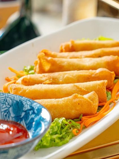 Another shot of our cheese and corn cigar rolls, served with ketchup on a bed of fresh shredded carrots.