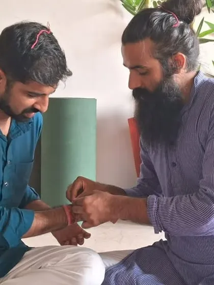 Performing Hawan together strengthens bonds and fosters a sense of unity. Here, a sacred thread is tied as part of the ceremony, symbolizing protection and connection within our community.