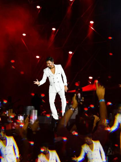 A creative, kaleidoscopic shot of an artist on stage, surrounded by the energy of the crowd. We experiment with visual effects in our post-event content to keep the vibe alive.