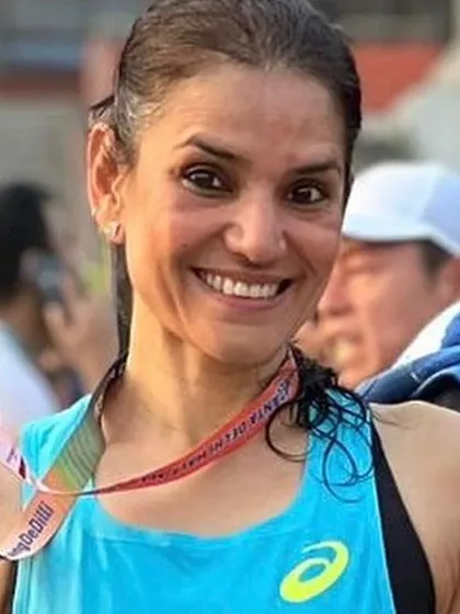 A smile of success. Dr. Indu Tandon holds up her medal after clinching second place at the Delhi Vedanta Marathon 10K with a new personal best time.