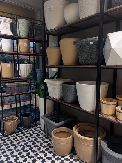The shelving at our Surathkal store is stocked with a variety of planters, from simple terracotta styles to modern geometric designs.