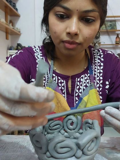 This student is adding the final touches to her coiled and decorated bowl. It's amazing to see how a few simple techniques can be combined to create something so textured and unique.