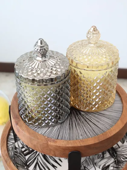 Our Crystal Cove scented candles in both smoke grey and amber glass. These beautiful jars can be repurposed long after the candle has burned, making them a sustainable luxury.