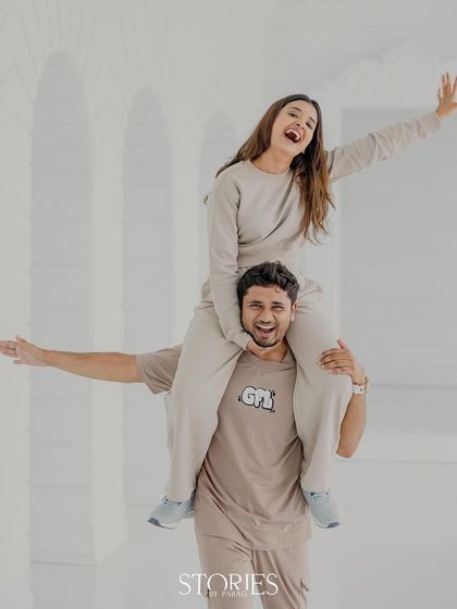 Pure, uninhibited fun. This dynamic shot captures the couple's playful energy and big smiles, creating a memory that is as fun as it is beautiful.