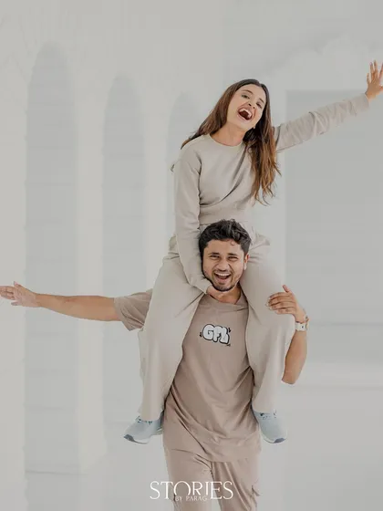 Pure, uninhibited fun. This dynamic shot captures the couple's playful energy and big smiles, creating a memory that is as fun as it is beautiful.