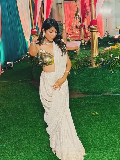 Another angle of my custom-designed saree look against a wedding decor backdrop. The flow of the drape and the sparkle of the blouse make it a showstopper for any evening event.