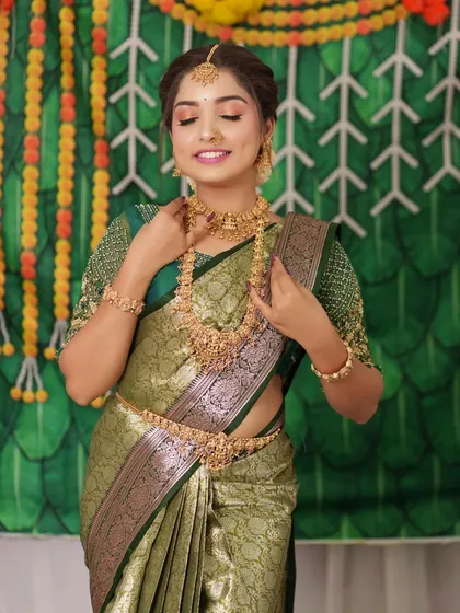 This bride chose a beautiful antique set to go with her olive green saree. The jewellery stands out beautifully.