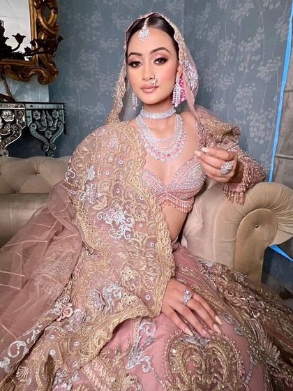 A full shot of the bride in her stunning pastel lehenga, looking like a modern-day princess.