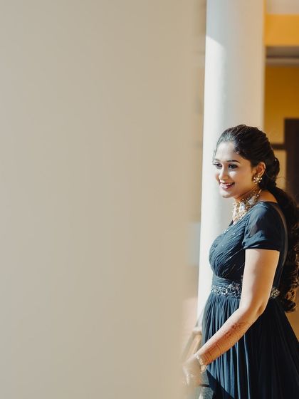 A candid, happy moment. The natural light beautifully captures the soft makeup and her joyful expression.