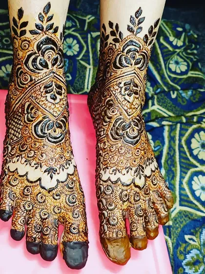 Your bridal look isn't complete without mehendi on your feet. I designed this piece with full coverage for the top of the feet, featuring bold floral and leaf patterns that climb up the ankles.