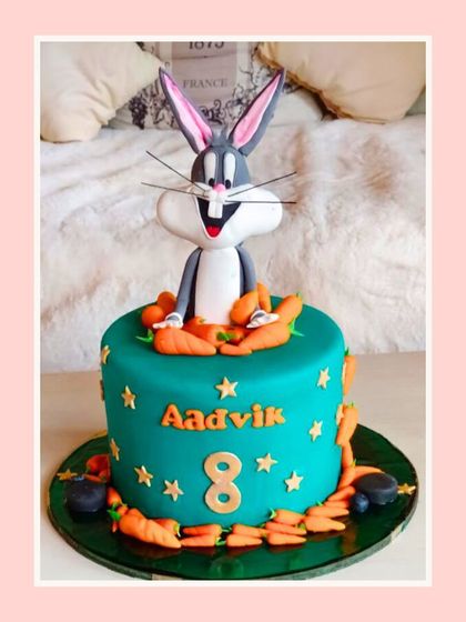 "What's up, doc?" A fun Bugs Bunny cake featuring the iconic character popping out of the top, surrounded by carrots.
