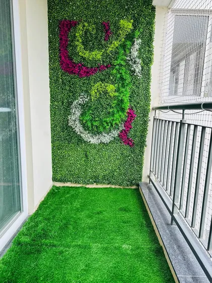 A custom 'Om' symbol created with different colored foliage for a client's balcony. This shows how we can incorporate personal symbols and spiritual art into your green wall design.