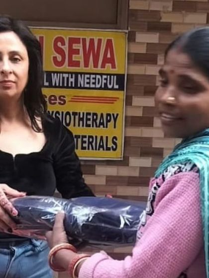 Another person receives a blanket, a moment that captures the direct impact of our *Sachi Sewa* initiatives.