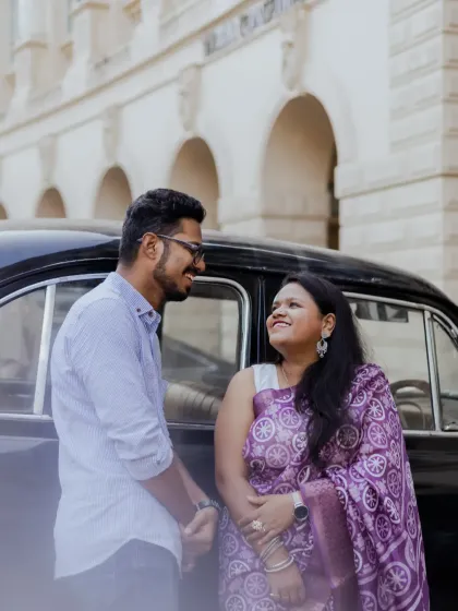 A classic and elegant pre-wedding photo with a vintage car. This couple's shoot in Mumbai captures a timeless, old-world charm.
