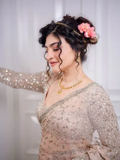 A close-up showing the soft curls and the beautiful, glowing makeup. The look is dreamy and sophisticated.