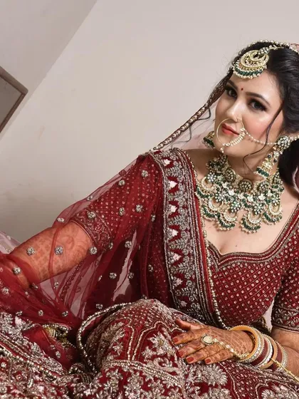 This candid shot captures the rich texture and detail of the maroon velvet rental lehenga. The heavy embroidery ensures you look spectacular in your wedding photos.