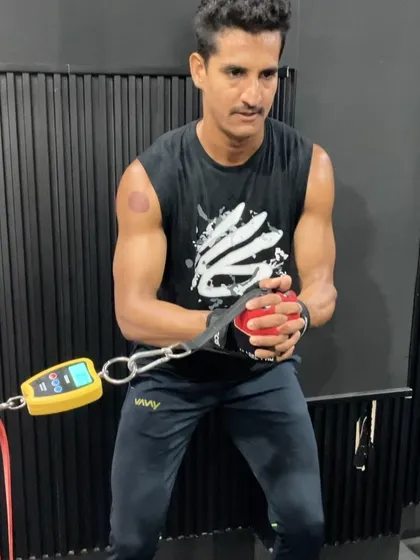 An athlete using a force gauge to measure rotational power during a cable pull, showcasing our data-driven approach to training.
