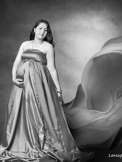 A beautiful black and white version of the flowing gown portrait. The monochrome tones emphasize the graceful lines of the dress and the serene emotion of the moment.