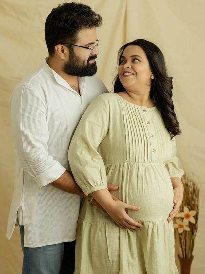 The smiles you share are just beautiful. This portrait is full of genuine happiness and the easy love between two people about to become parents.