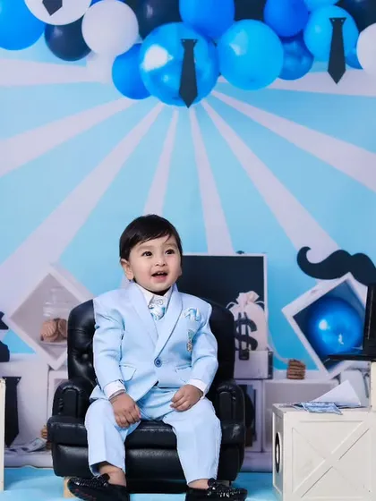 For the little boss in your life, our 'Boss Baby' theme is a fun and playful option. We use creative backdrops and props like this miniature leather chair to set the perfect scene.