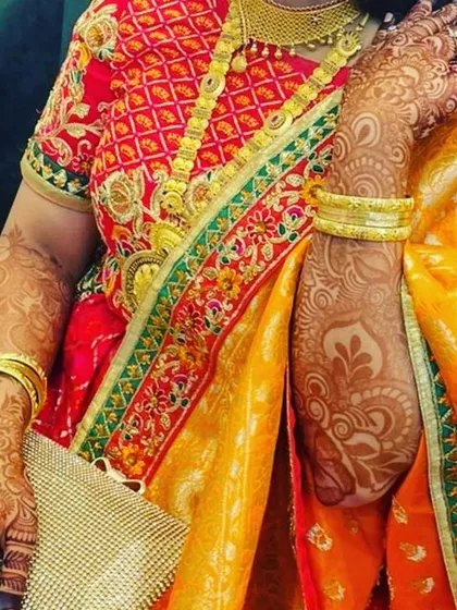 A client dressed up for her brother's engagement. Her henna stain has developed into a lovely color that perfectly complements her traditional saree.