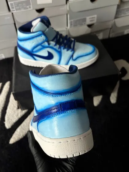 A heel view of the blue cartoon custom Jordans.