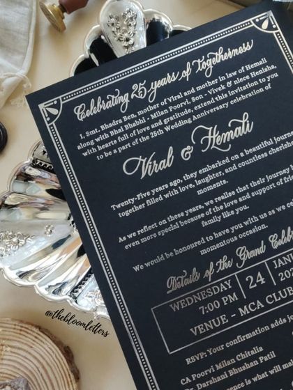 The full text of the 25th-anniversary invitation, showcasing a mix of script and block fonts printed in silver on black paper for a modern yet timeless feel.