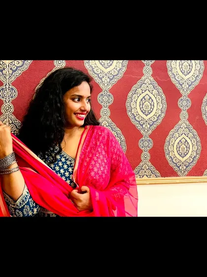 A closer look at my friend's wedding outfit. The combination of a printed blue kurta with a vibrant pink dupatta and silver bangles creates a balanced and eye-catching festive look.