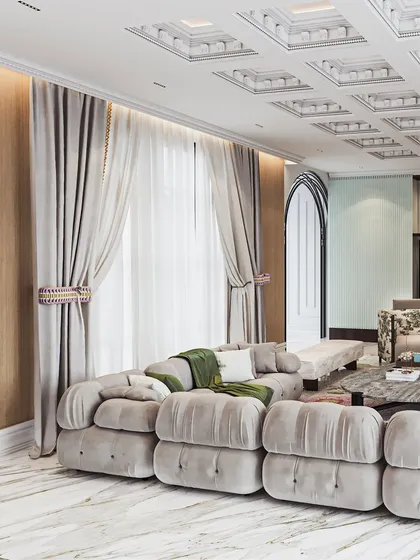 A living and dining space where a plush, modular sofa and a coffered ceiling create a sense of relaxed grandeur.