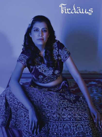 A beautiful portrait from a 40th birthday shoot. The blue lighting and traditional attire create a regal and celebratory mood.