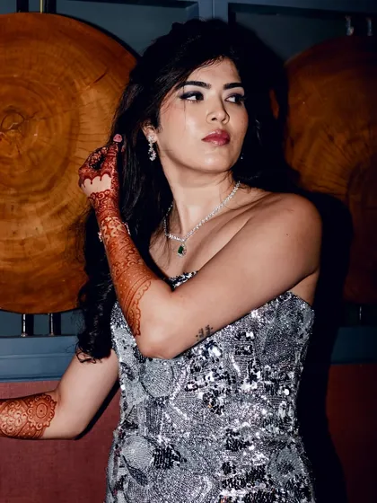 A powerful and chic pose from Reeya's cocktail night. The makeup is bold and defined, perfect for an evening of celebration.