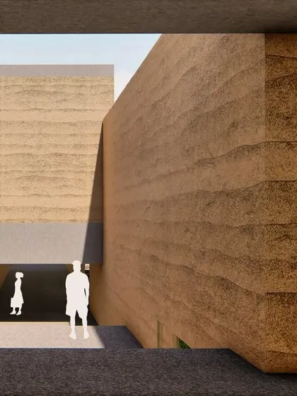 A view from an upper level in the rammed earth retreat concept, looking down into a courtyard. The design uses verticality to create complex spatial relationships.