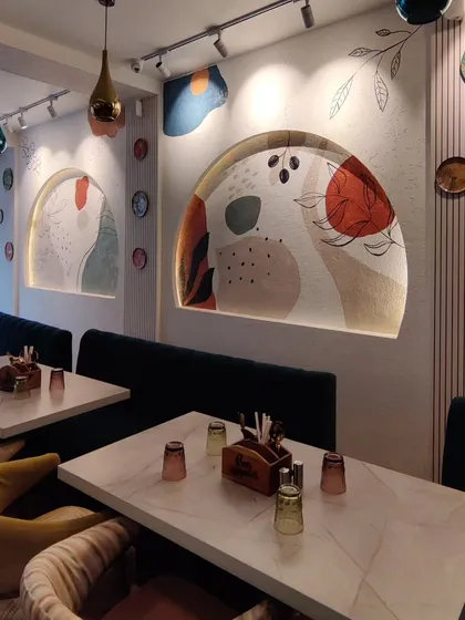 I love collaborating with businesses to bring their brand's personality to life. For this Delhi cafe, I designed a series of abstract Boho murals within arched nooks, creating a warm, trendy, and inviting atmosphere for customers.
