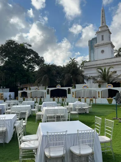 The pristine white table setup against the backdrop of a historic building, showcasing the grand scale of events I cater.