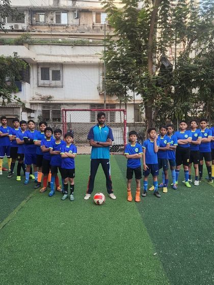 The complete HB Sports football team, standing united with their coach. This powerful image represents the discipline, strength, and collective ambition of our squad.