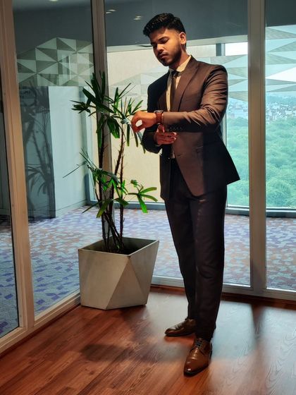 Another angle of the cocoa brown suit, showcasing its fit and how it looks in a professional setting.