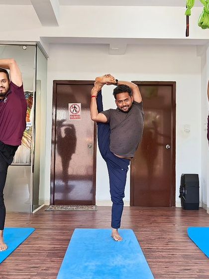 Our instructors demonstrating advanced standing balance poses together, showcasing skill and synchronization.