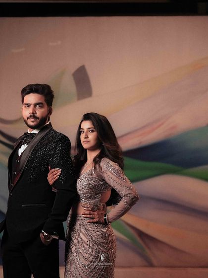 A stylish portrait of the couple against a colorful, abstract background.