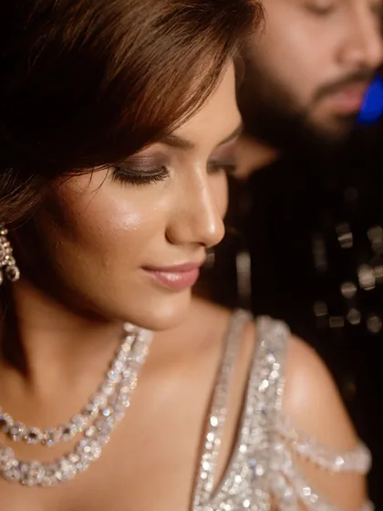A close-up of the bride's glamorous sangeet makeup. The smokey eye and nude lip combination is a classic choice for an evening event.