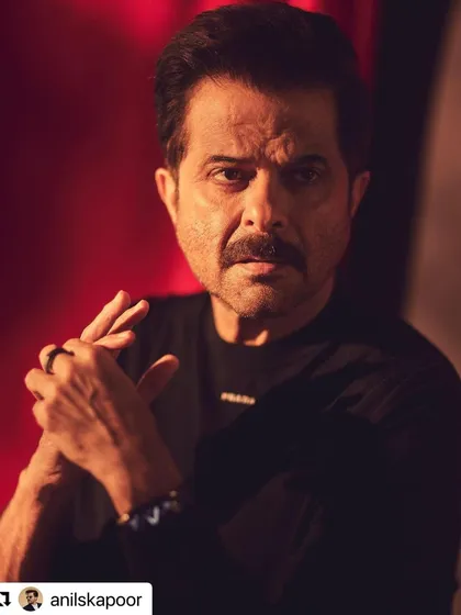 An up-close and personal shot of Anil Kapoor. The warm, dramatic lighting accentuates the texture of his hair.