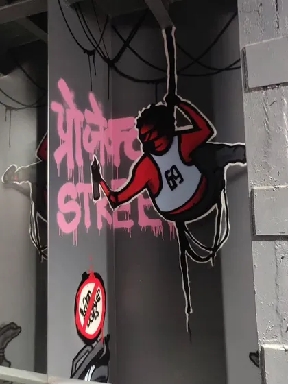 Another interior piece for Projekt Street, featuring a character hanging from wires. This artwork plays with the urban theme of the store, bringing the outside street vibe indoors.