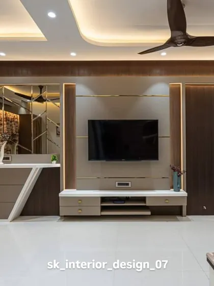 A complete entertainment wall with a TV console, mirrored panels, and a vanity table. The consistent use of wood and neutral tones creates a harmonious and functional space.