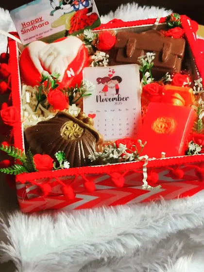 A luxurious Sindhara hamper for a special celebration. It includes personalized couple soaps, purse and laptop-shaped soaps, and a calendar soap, all in a beautifully decorated box.